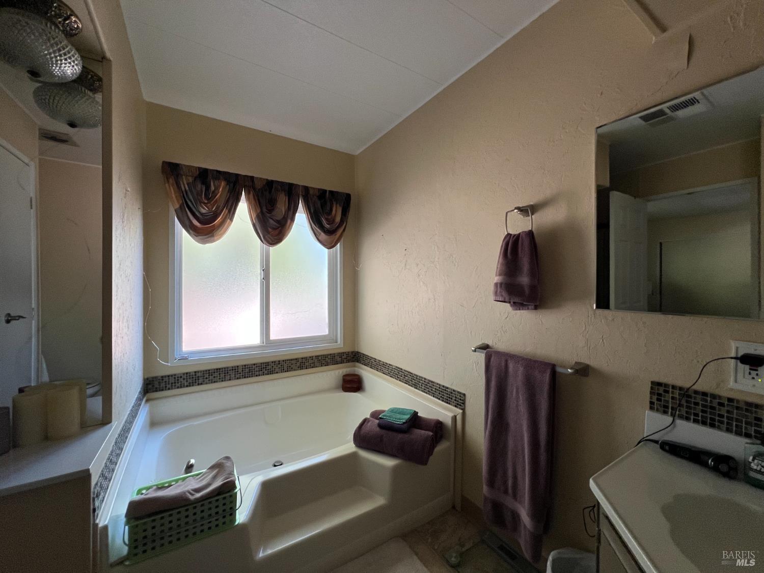 161 Bear Flag Road Sonoma, CA 95476 - Photo 21 of 57 a bathroom with a bathtub sink and mirror