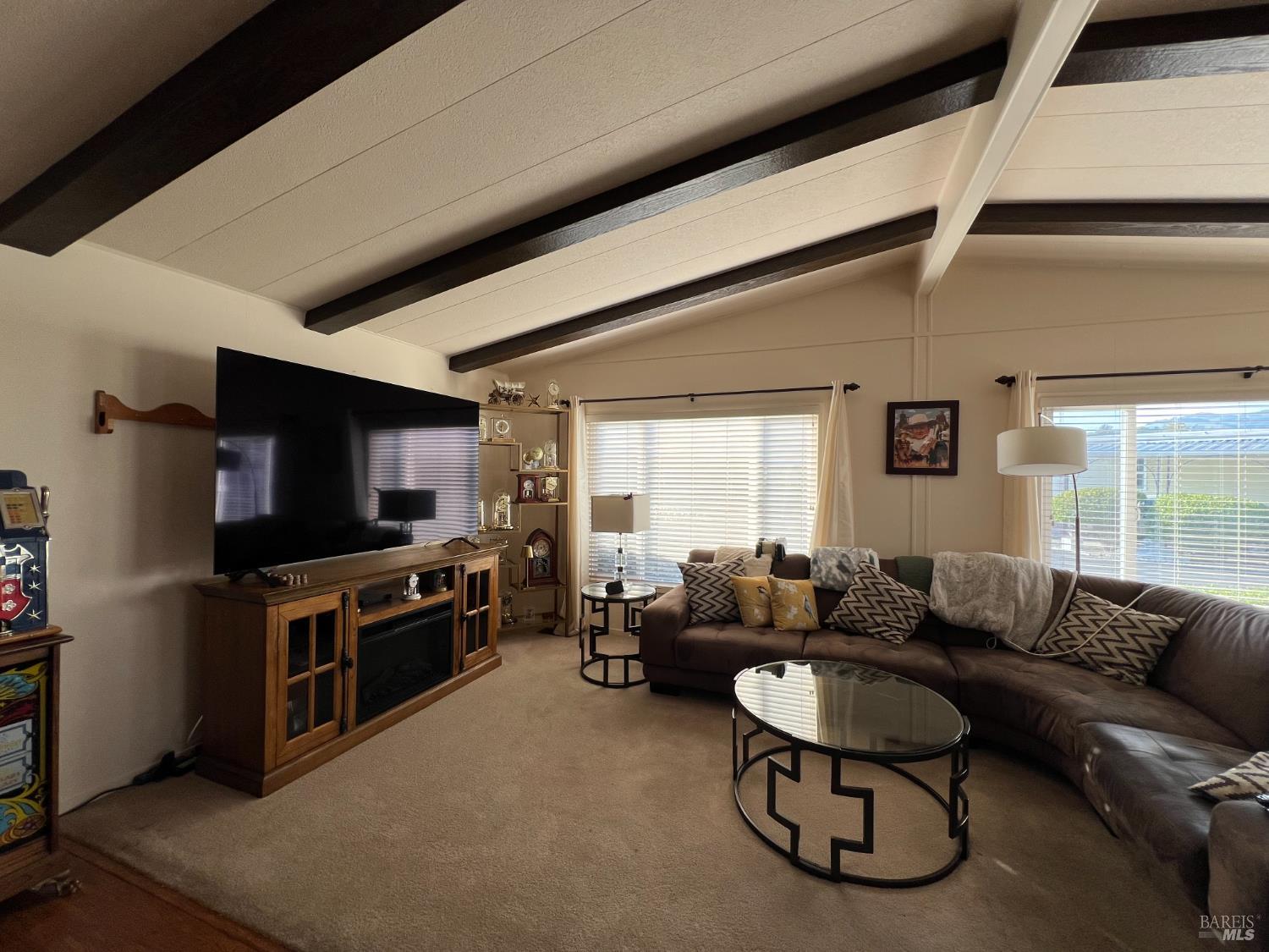 161 Bear Flag Road Sonoma, CA 95476 - Photo 36 of 57 a living room with furniture a flat screen tv and a refrigerator