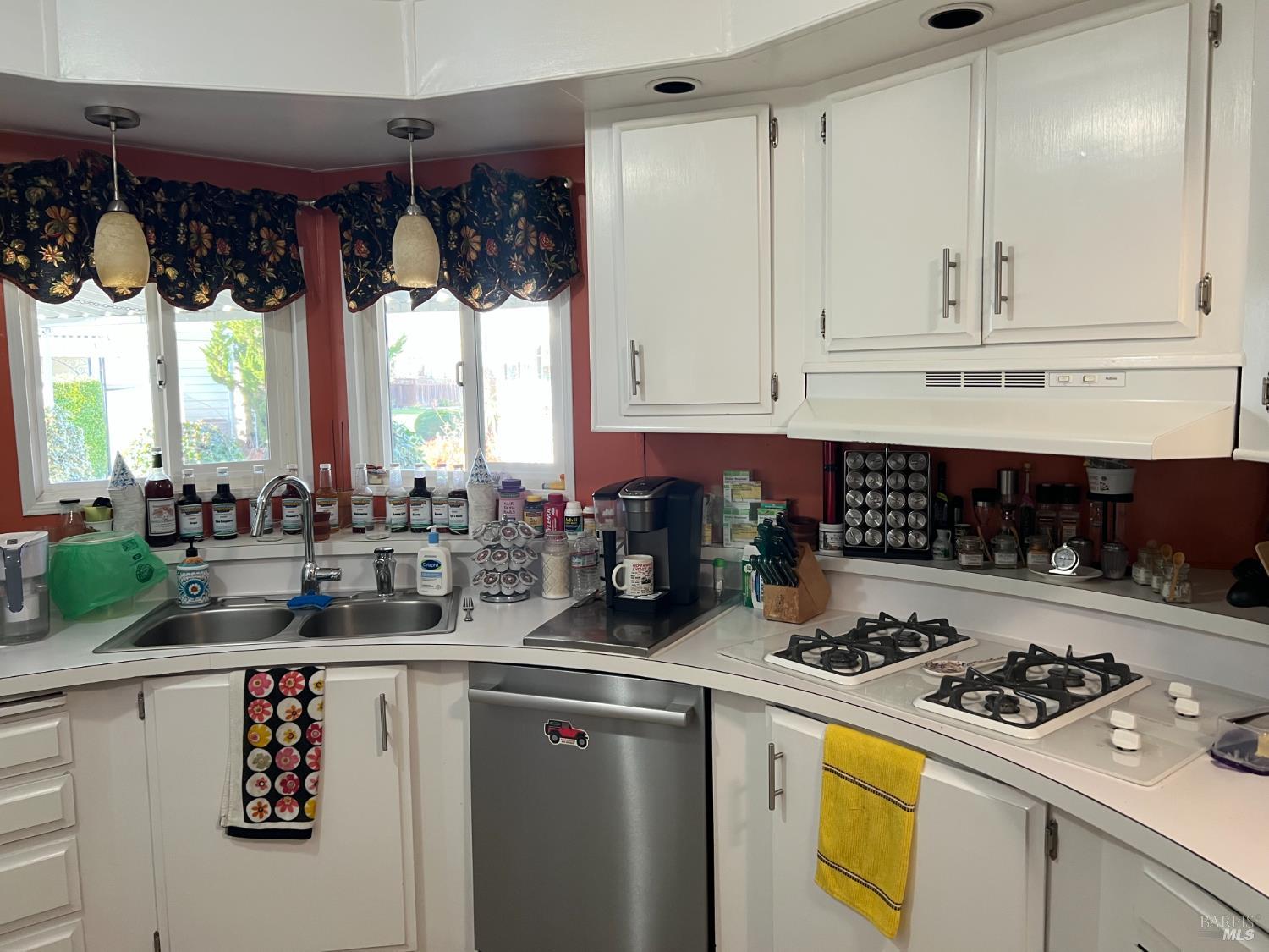 161 Bear Flag Road Sonoma, CA 95476 - Photo 40 of 57 a kitchen with a stove a refrigerator and a white cabinets