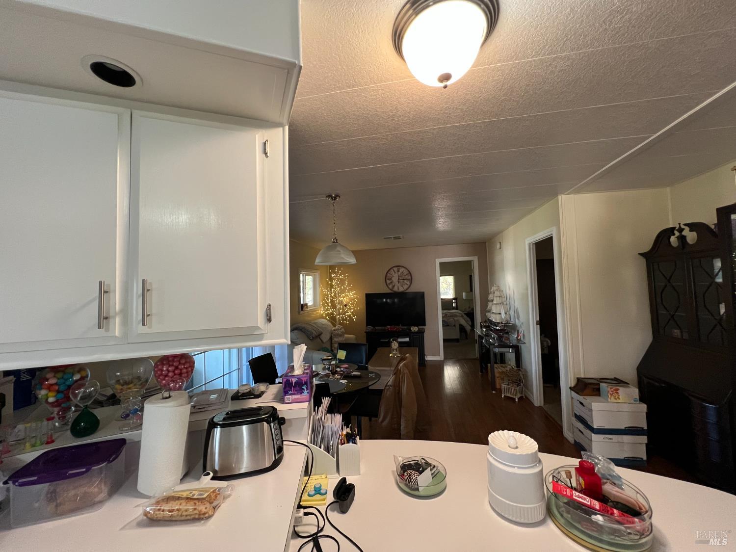 161 Bear Flag Road Sonoma, CA 95476 - Photo 44 of 57 a kitchen with a sink dishwasher and a dining table with wooden floor