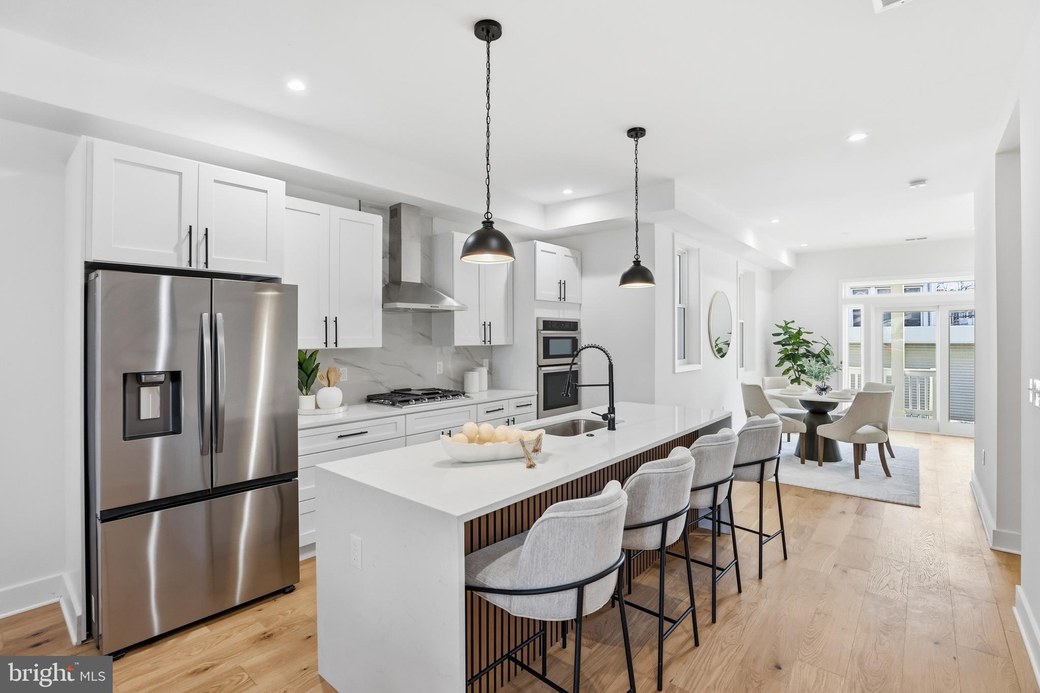 2815 North Capitol Street Northeast Washington, DC 20002 - Photo 11 of 87 a kitchen with stainless steel appliances a refrigerator a stove a dining table and chairs