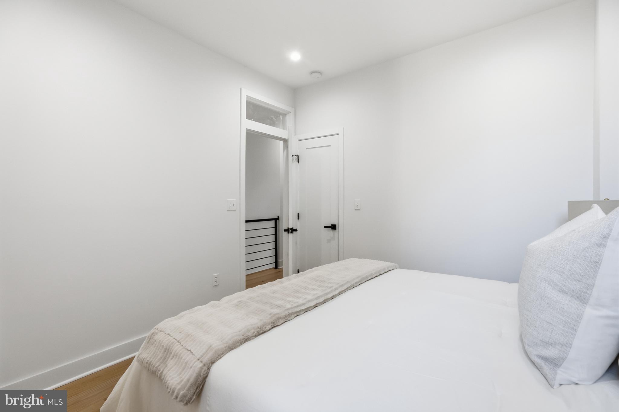 2815 North Capitol Street Northeast Washington, DC 20002 - Photo 39 of 87 a bedroom with a bed and a white wall