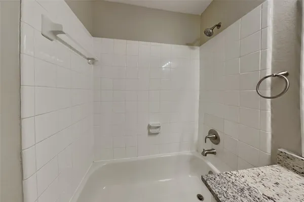a bathroom with a bathtub and shower