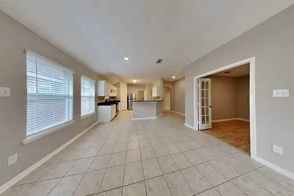 a view of empty room with cabinet and mirrors