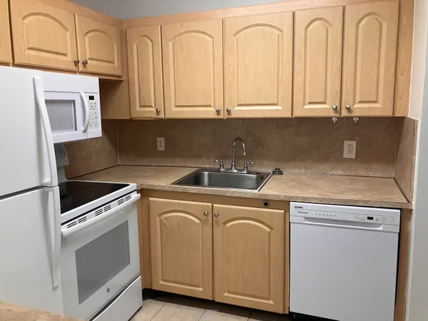 a view of a kitchen with sink and washing machine