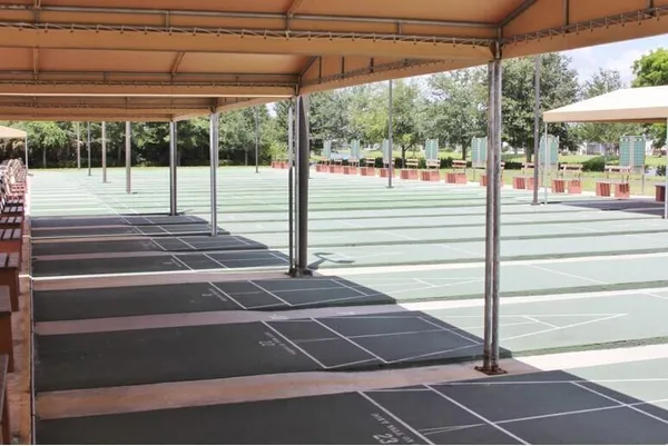 a view of a tennis court with a fountain