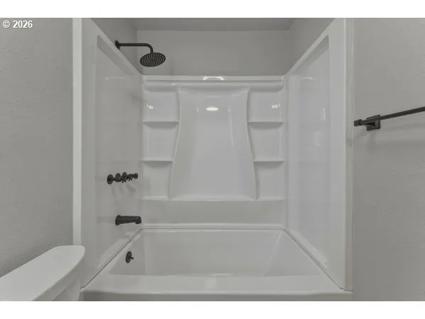 a bathroom with a bathtub and shower