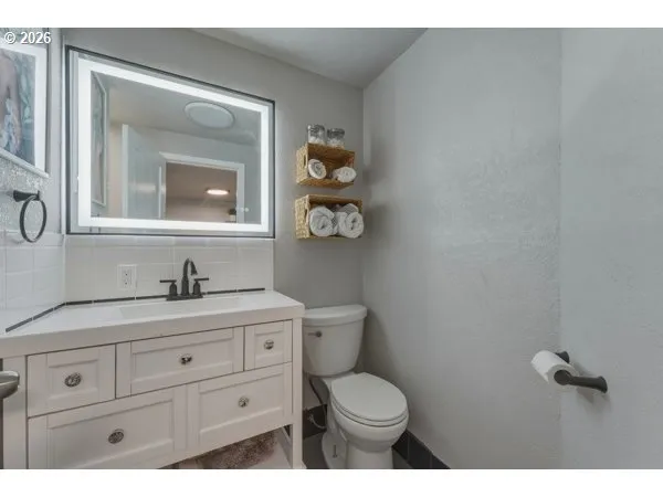 a bathroom with a toilet a sink and mirror