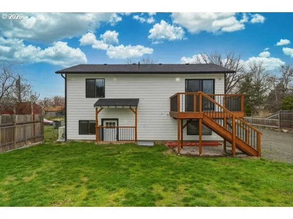 a view of a house with a yard and a chair