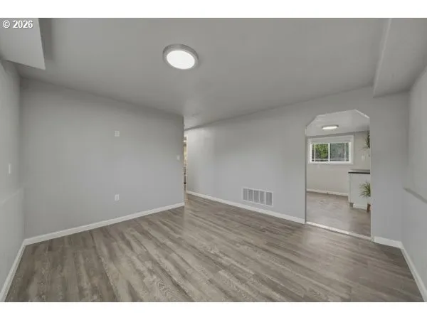 a view of an empty room and wooden floor