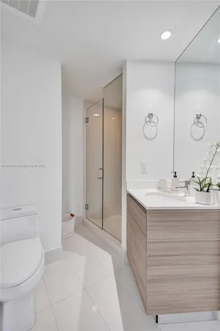 a spacious bathroom with a granite countertop sink a toilet and a shower
