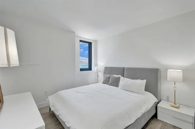 a bedroom with a bed and a lamp