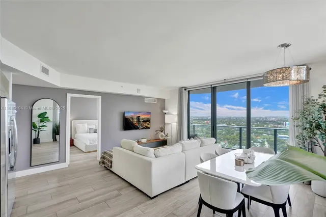 a living room with furniture and a large window