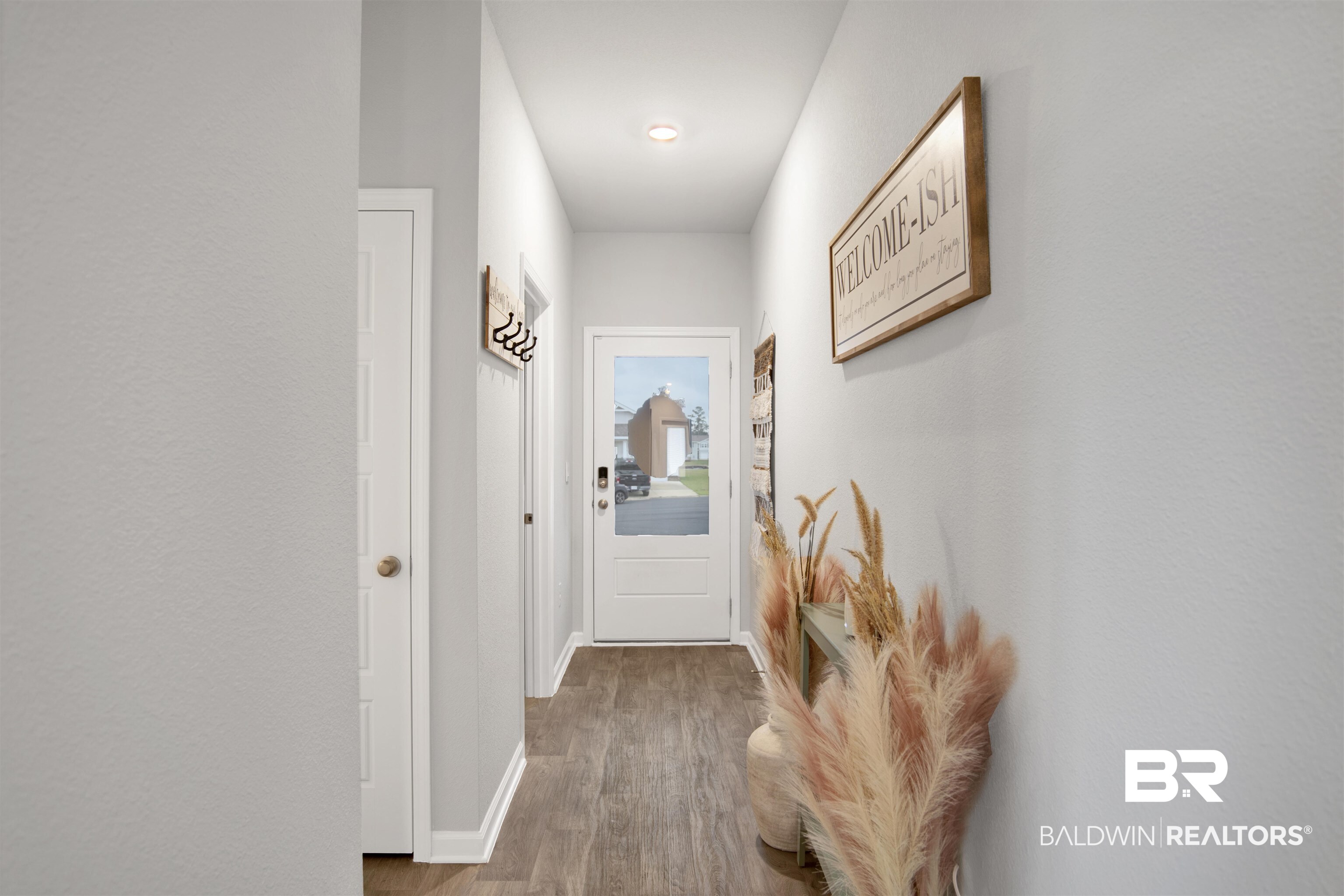 12813 Patriot Way Daphne, AL 36527 - Photo 11 of 23 Entryway with wood-finish flooring, white trim, and light gray walls