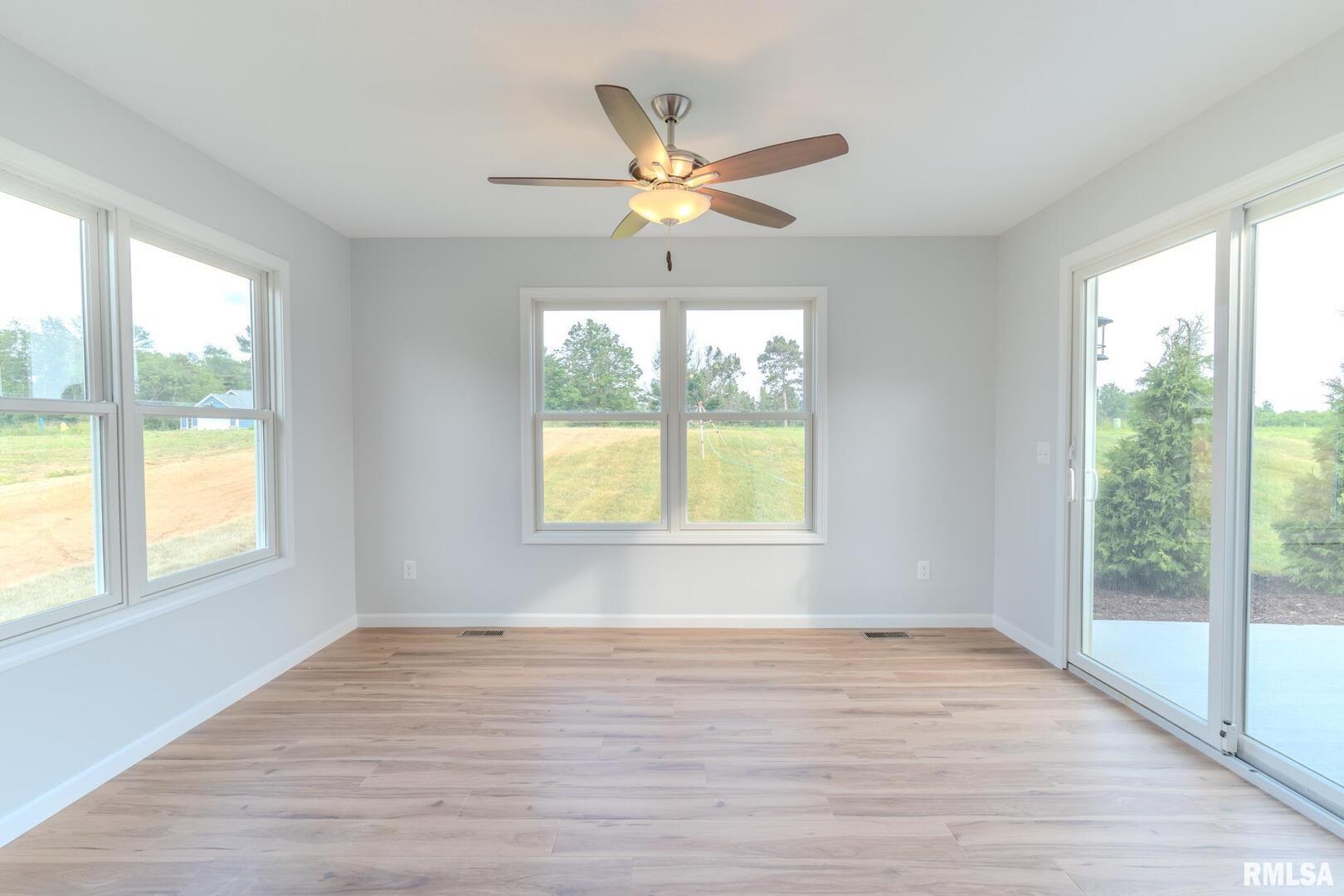 941 9th Avenue North Clinton, IA 52732 - Photo 8 of 24 a view of an empty room with wooden floor and a window