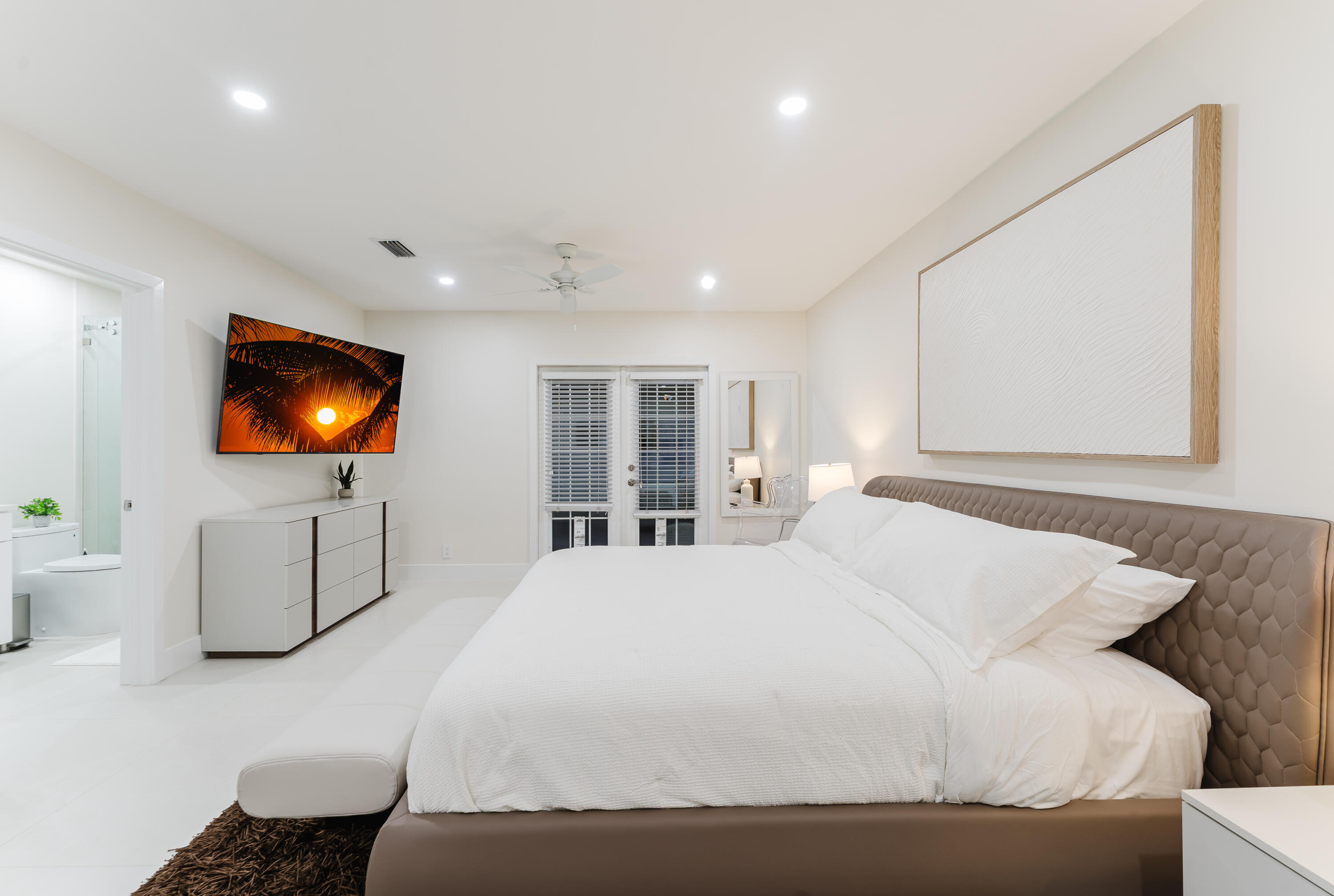 3199 Northeast 6th Drive Boca Raton, FL 33431 - Photo 26 of 49 a bedroom with a bed and a flat screen tv