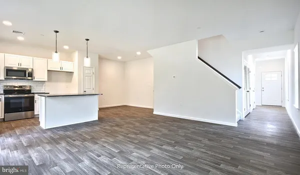 a view of kitchen with kitchen island granite countertop a stove top oven and a sink with granite countertops