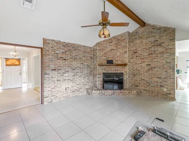 a view of empty room with a fireplace