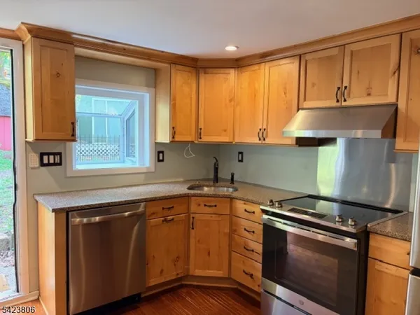 a kitchen with wooden cabinets and a stove top oven