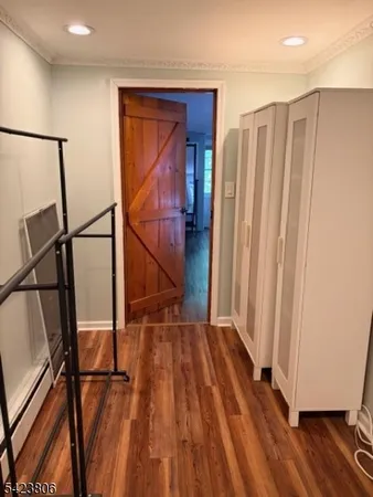 a view of front door with wooden floor and stairs