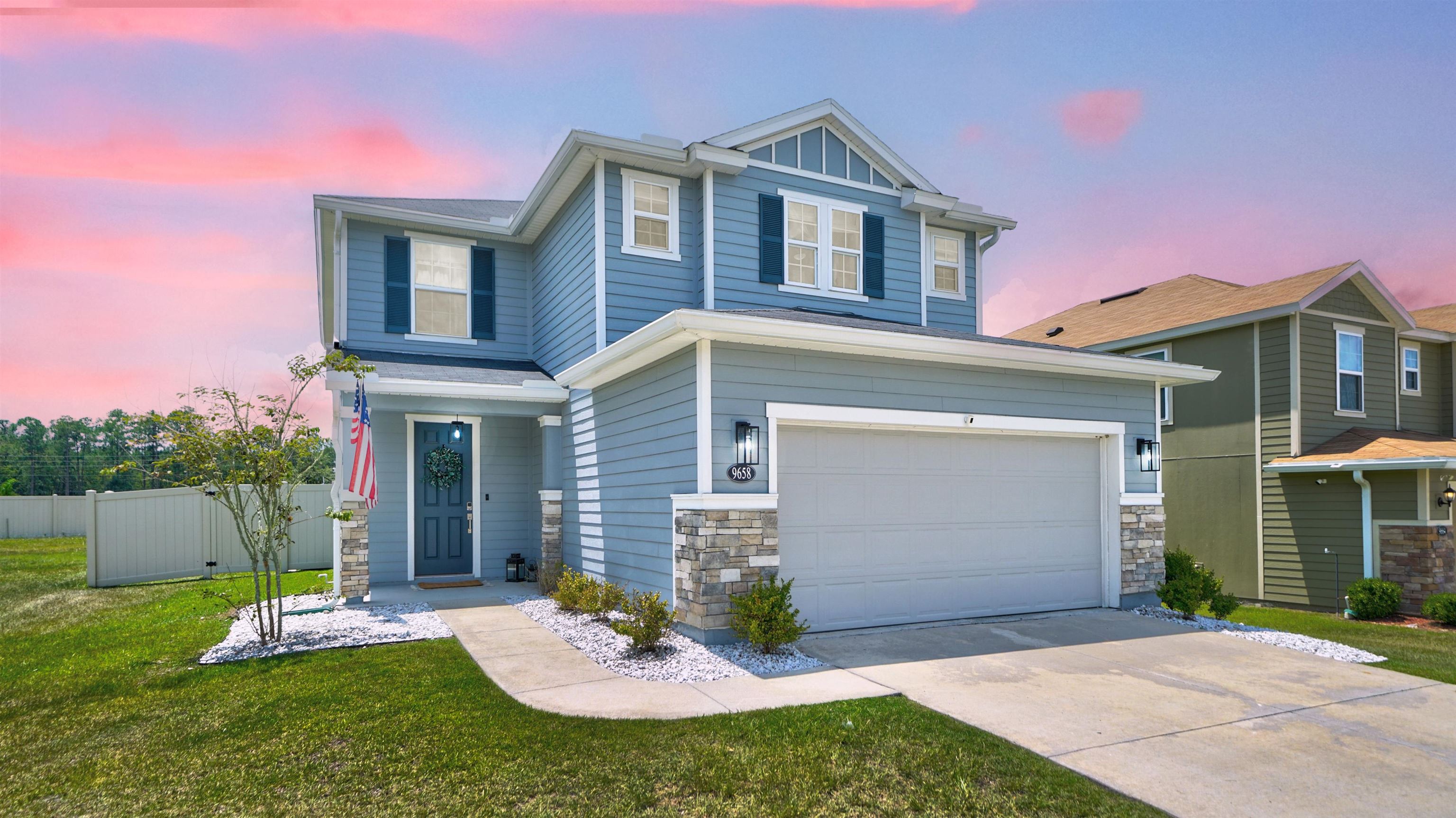 a front view of a house with a yard and garage