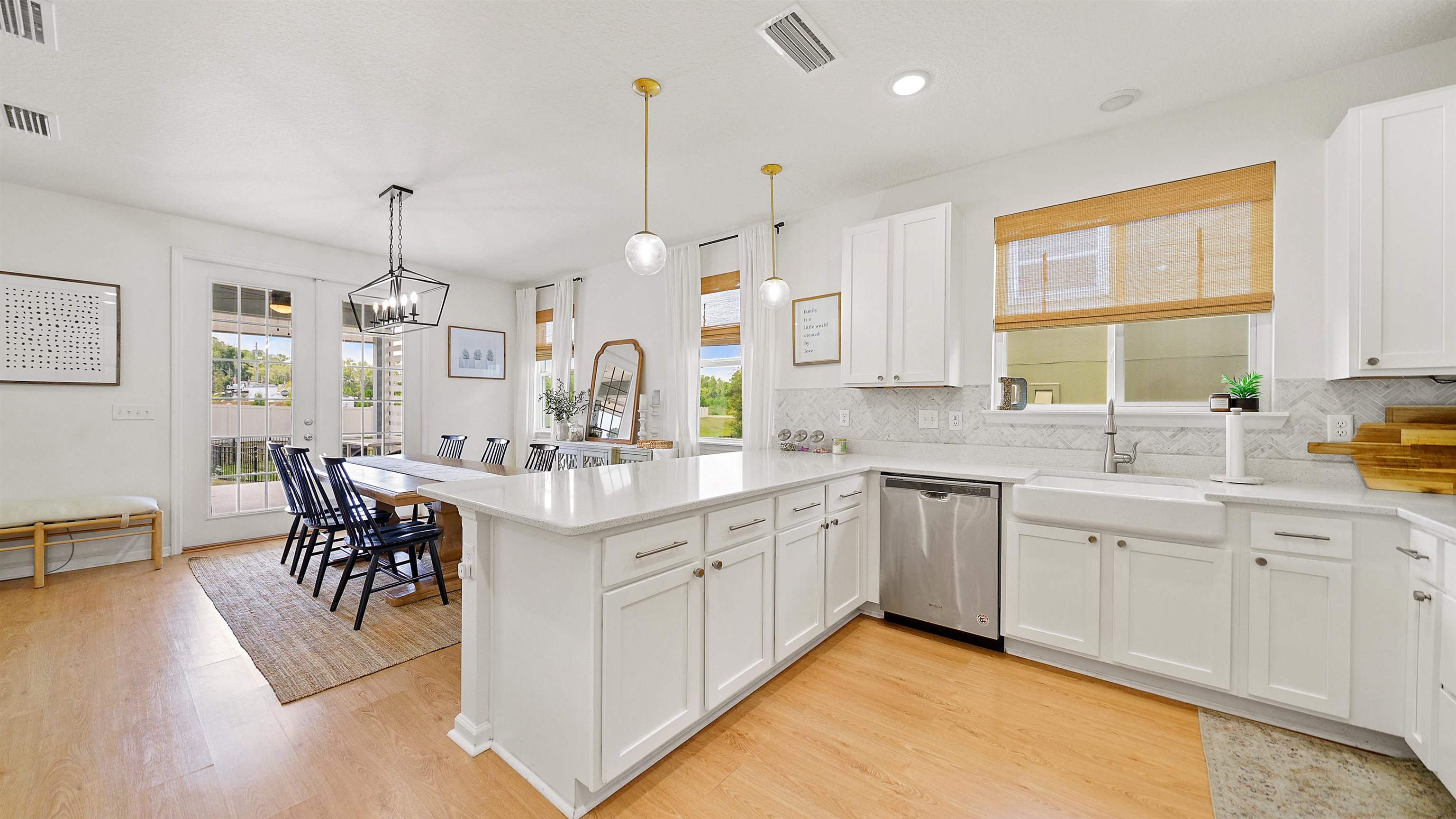 9658 Freefall Road Jacksonville, FL 32221 - Photo 13 of 39 a large kitchen with kitchen island a sink table and chairs