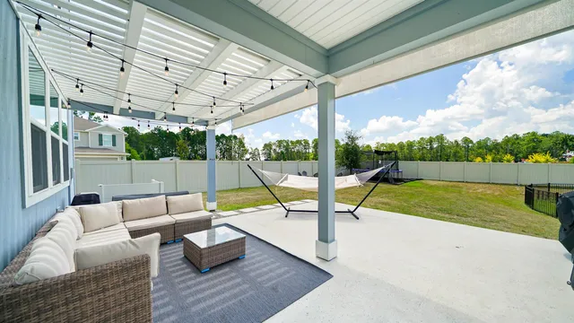 a view of swimming pool with a couches in a patio