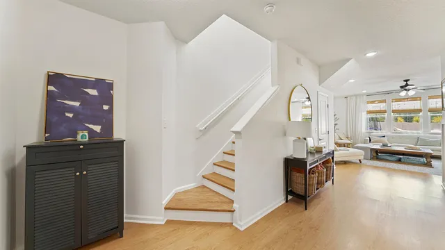 a view of a livingroom with furniture and hardwood floor