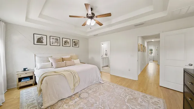 a spacious bedroom with a bed and a ceiling fan