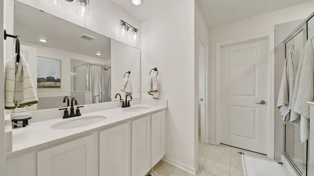 a bathroom with a double vanity sink mirror and