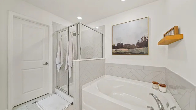 a bathroom with a bathtub and a shower