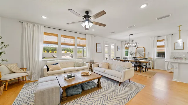 a living room with furniture and wooden floor
