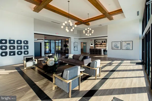 a living room with furniture and chandelier