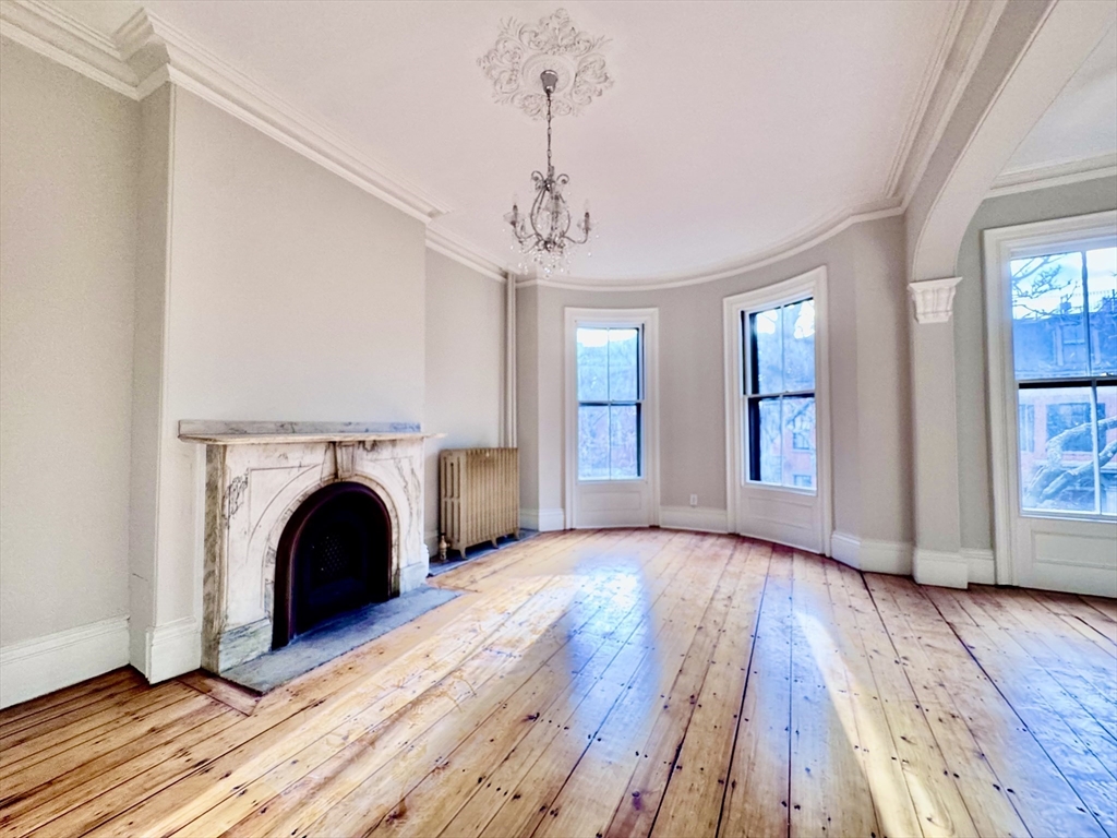 169 West Brookline Street, Unit PH Boston, MA 02118 - Photo 14 of 19 a view of an empty room with wooden floor and a window