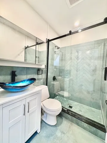 a utility room with wooden floor and washing machine