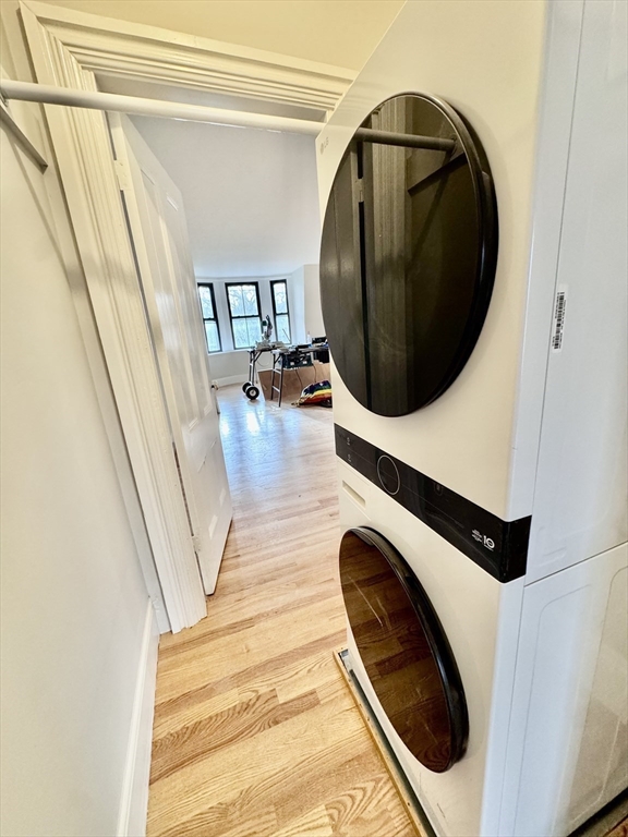 169 West Brookline Street, Unit PH Boston, MA 02118 - Photo 17 of 19 a utility room with wooden floor and washing machine
