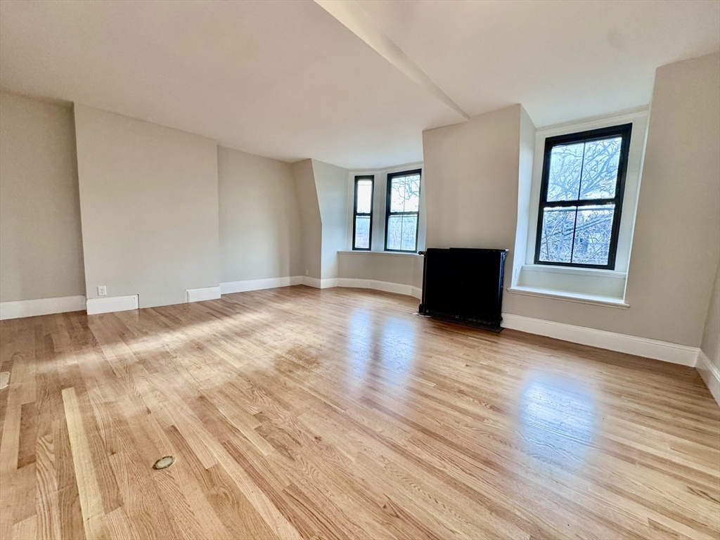 169 West Brookline Street, Unit PH Boston, MA 02118 - Photo 2 of 19 a view of an empty room with wooden floor and a window