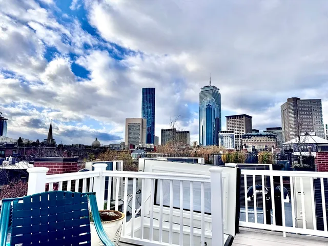 a view of a chair and tables in the balcony