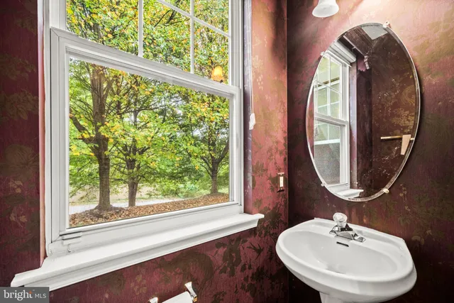 a bathroom with a mirror and a sink