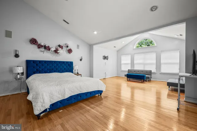 a spacious bedroom with a bed and a window