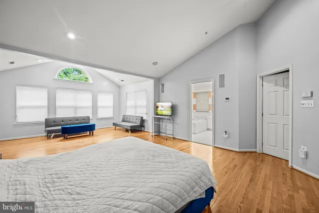 a spacious bedroom with a bed and a table in it