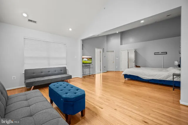 a bedroom with a bed window and couch