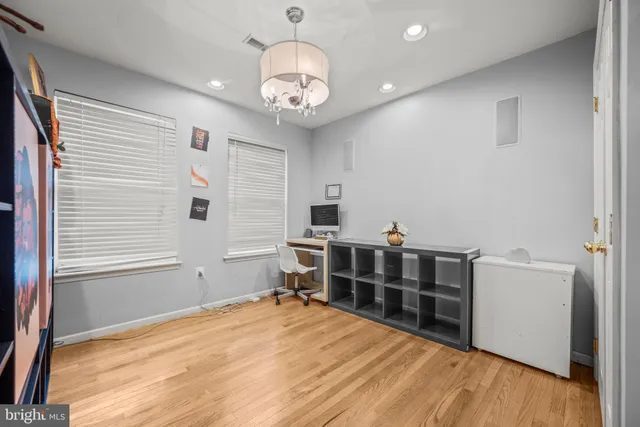 a view of a room with furniture and wooden floor