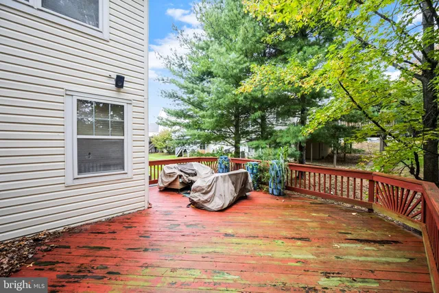 a roof deck with couches and wooden fence