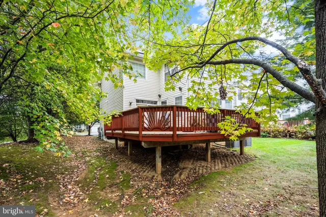 a view of a wooden chairs in backyard of house