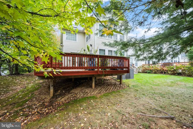 a wooden bench sitting in the middle of a yard