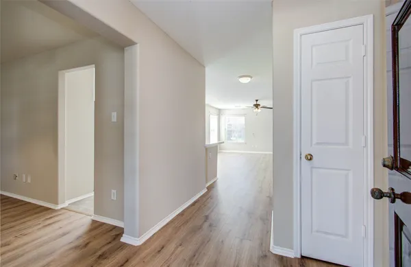 a view of a hallway with wooden floor