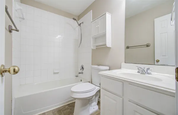 a bathroom with a sink toilet vanity and shower