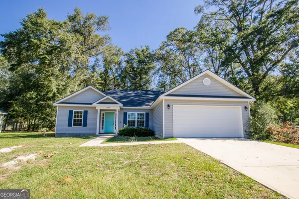a front view of a house with a garden
