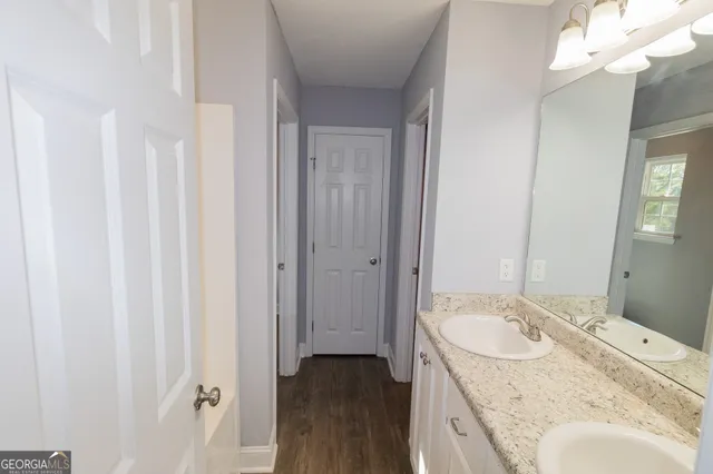 a bathroom with a granite countertop sink and a mirror